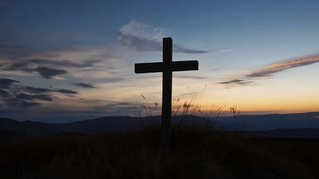 Wooden cross stands on a hilltop, silhouetted against a stunning sunset, creating a serene and spiritual atmosphere