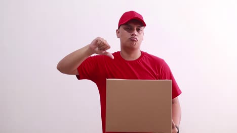 Young-asian-courier-man-holding-a-cardboard-while-showing-thumbs-down