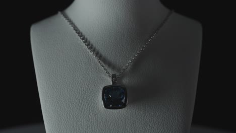 blue gemstone on a necklace on a bust