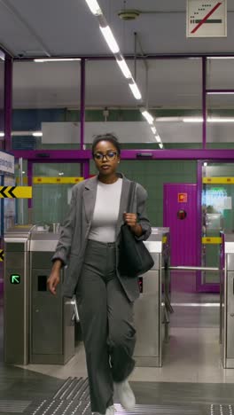 woman passing through subway gate