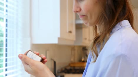 Worried-woman-standing-in-kitchen-4k