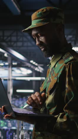 vertical video army it specialist in data center uses laptop to defend networks against threats