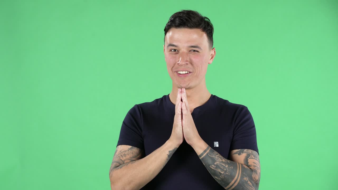 Portrait of a handsome young guy is looking at camera with shocked and surprised wow face expression and saying oh my god. Green screen