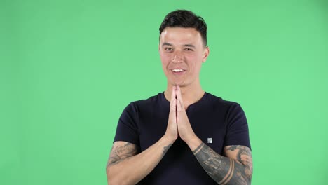 portrait of a handsome young guy is looking at camera with shocked and surprised wow face expression and saying oh my god. green screen