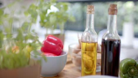 Close-up-of-vegetables-and-oils-in-kitchen,-slow-motion