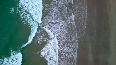 waves crashing down on a beach