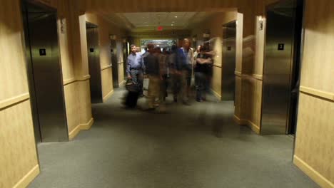 a time lapse of hotel patrons as they enter and exit elevators