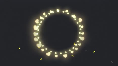 Animation-of-circle-of-glowing-heart-christmas-fairy-lights-over-gold-confetti,-on-black