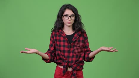 young confused hipster woman shrugging shoulders