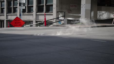 Slow motion street shot of steam coming from street in Seattle.