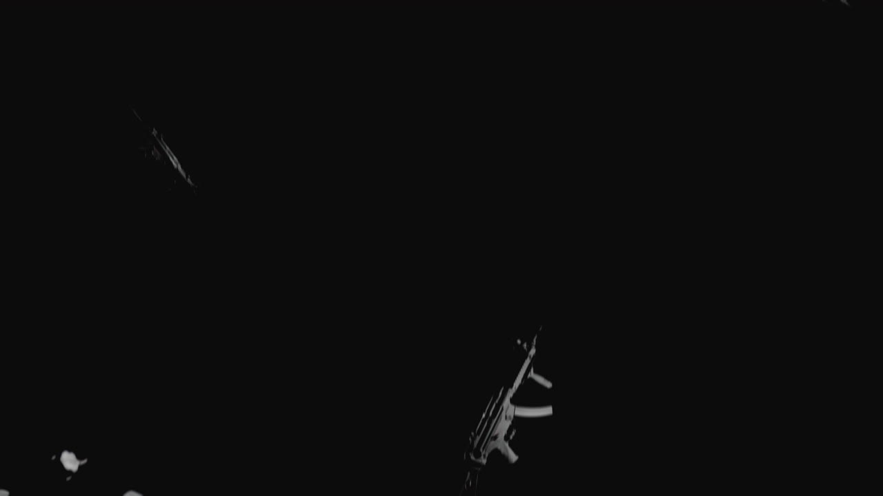 Machineguns on the dark background and in blinking lights are falling in slowmotion