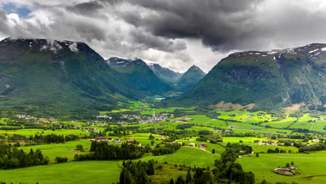 Gray-Clouds-On-A-Sunny-Day-Over-Mountains-And-Fields-In-Byrkjelo,-Vestland,-Norway