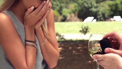 man offering engagement ring while proposing to woman