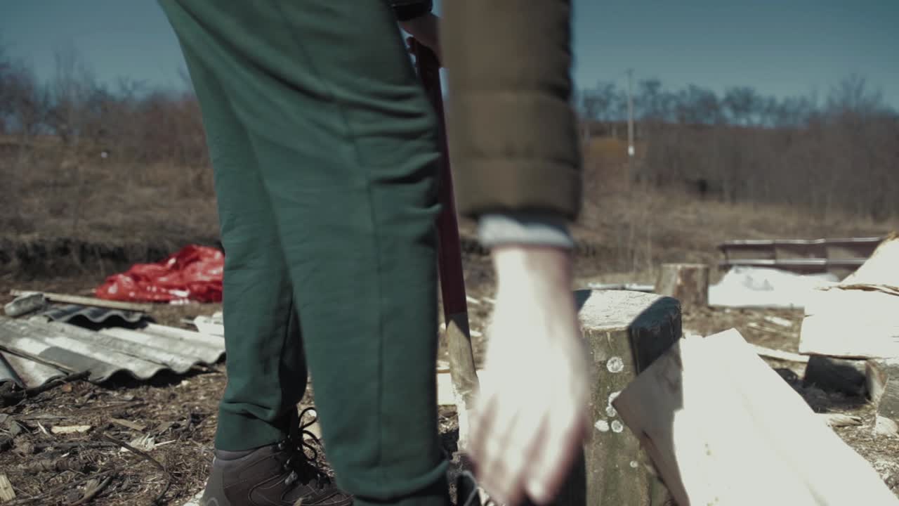 Cracking fire wood with a bad axe