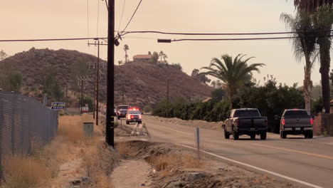 cars pull off road allowing the speeding fire brigade to pass on way to a blaze