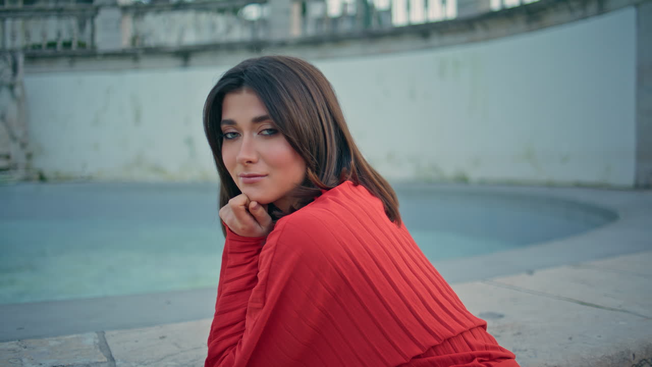 Dreamy woman watching city at evening fountain square closeup. Lady posing alone
