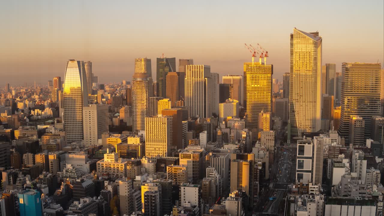 Sunrise on Tokyo sky scrapers time lapse sun moving over buildings, 4k panning right