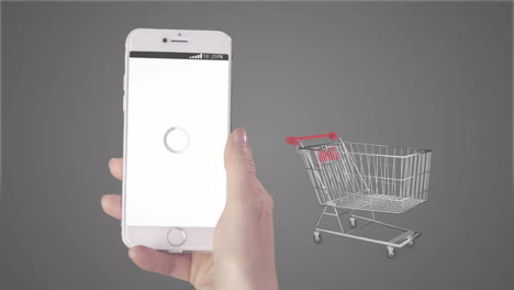 animation of person holding smartphone with online shopping on screen and trolley on grey background