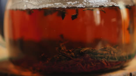 close-up of tea brewing in a glass teapot