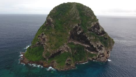 aerial drone shot during cloudy day. flying around le rocher diamant in martiniq