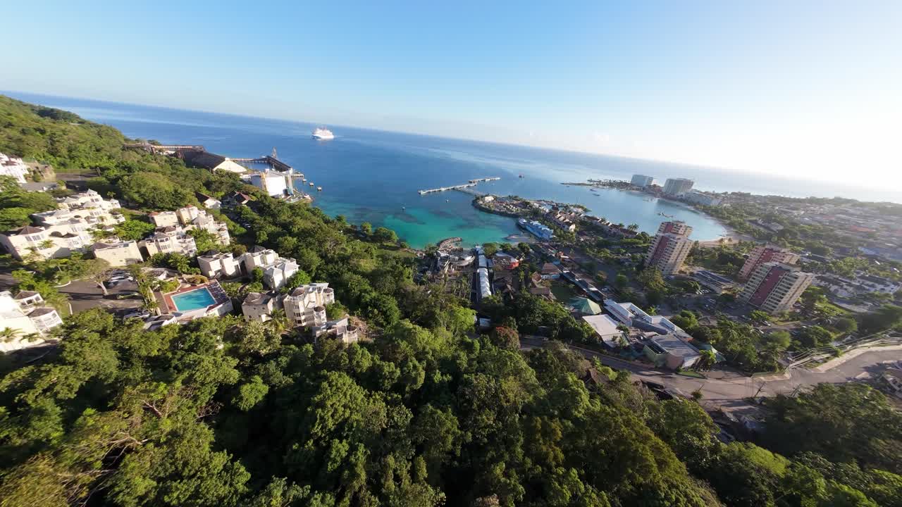 Dynamic FPV drone footage of Ocho Rios Harbor in Jamaica, showcasing boats, coastal waters, and the bustling port with immersive aerial motion.