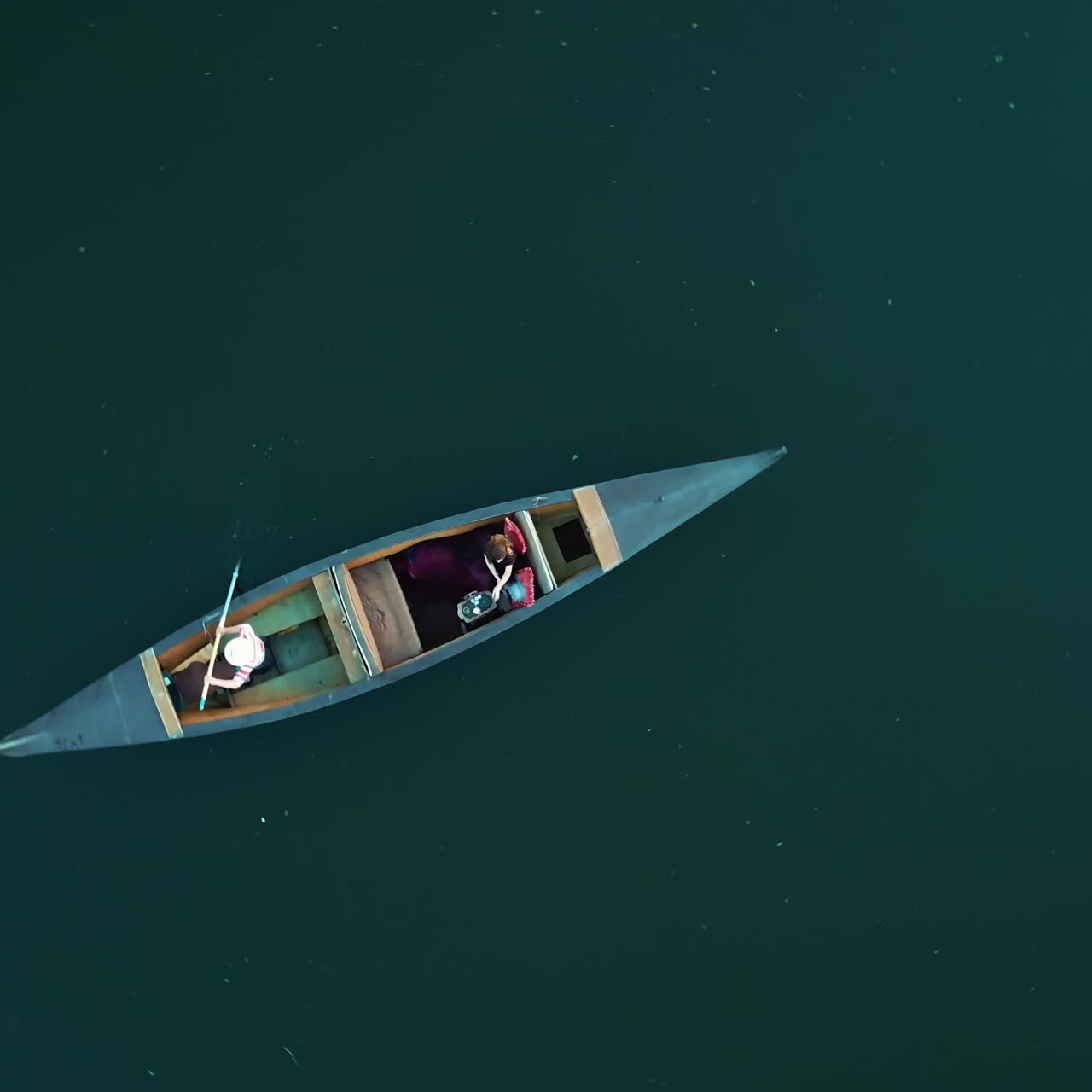 Aerial view woman traveling by boat at sunset. Gondola floating along the river