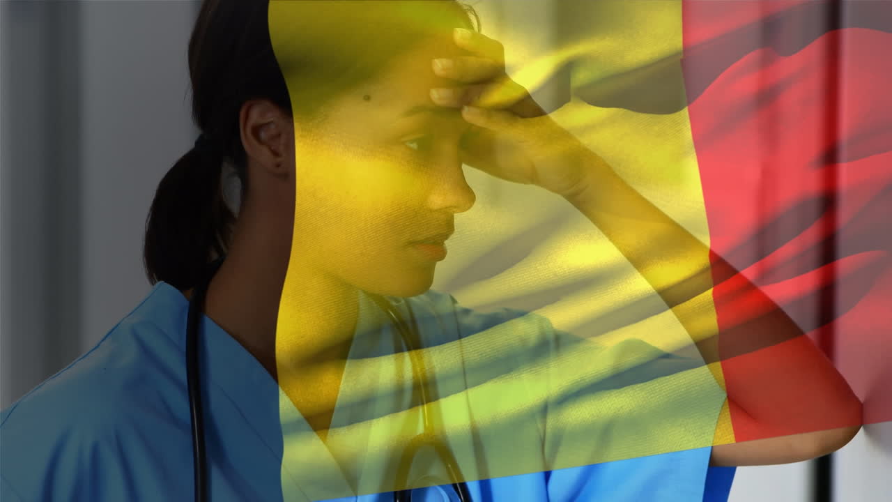 Bandiera del Belgio che sventola sullo sfondo di un'operatrice sanitaria afroamericana stressata in ospedale
