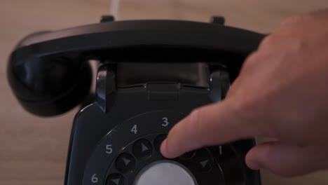 close-up of dialing numbers on a vintage rotary dial phone