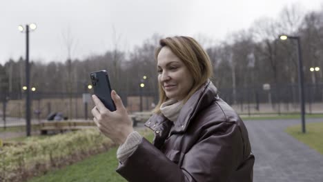 woman using phone in a park