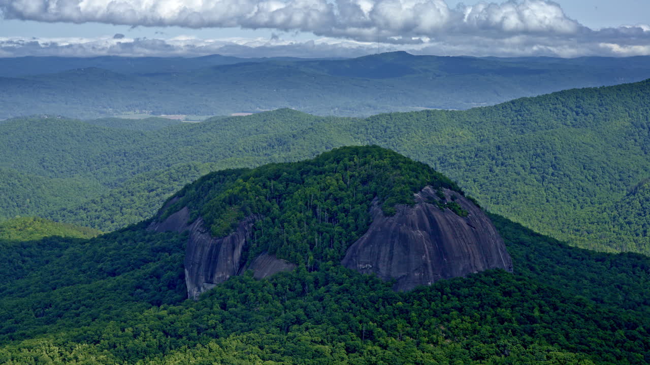 Lone summit captured by drone, distanced from the ridgeline around it