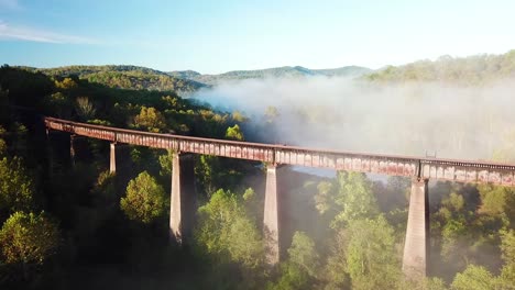 beautiful aerial over a steel railway trestle in the fog in west virginia appalachian mountains 2