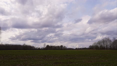 fast moving dense cloud timelapse over latvian countryside crop field
