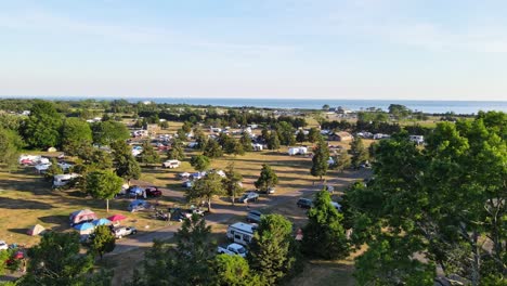 rvs and campers stationed at a campsite called hammonasset state park in connecticut facing the atlantic ocean