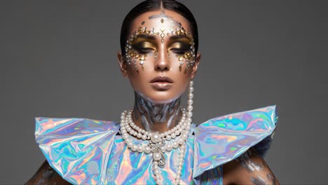 a stunning display of avant-garde fashion featuring a model adorned with intricate body art, daring makeup, and eye-catching accessories in a futuristic aesthetic