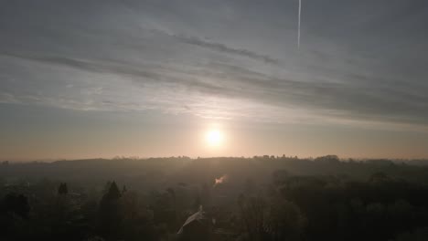 sun over misty winter landscape aerial slow motion warwickshire uk