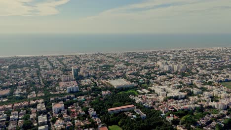 wide angle aerial shot of densly built city stretching towards coastline.