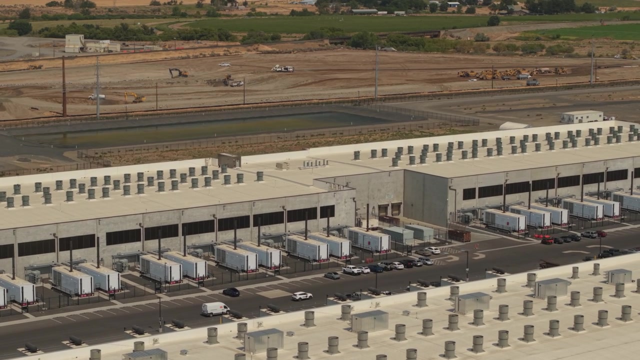 Data center campus in Hermiston, Oregon, with large server buildings, backup power equipment, utility systems, and extensive digital technology operations.