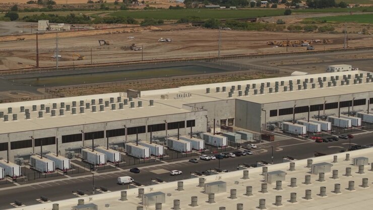 Data center campus in Hermiston, Oregon, with large server buildings, backup power equipment, utility systems, and extensive digital technology operations.