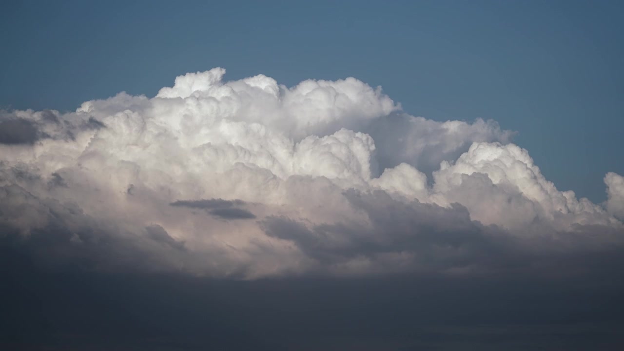 Time Lapse of Large White Cumulus Clouds Moving Across Blue Sky