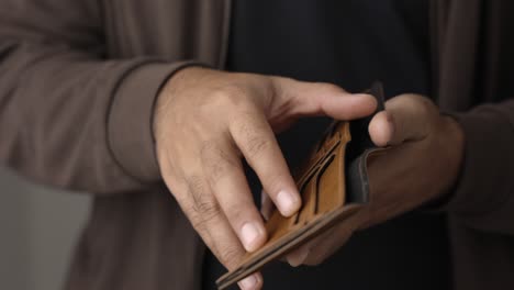 close up male hand open the empty wallet.there is no money in wallet. financial business concept.