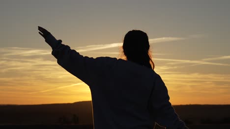 woman silhouette morning yoga stretching at sunrise sunset, positive energy