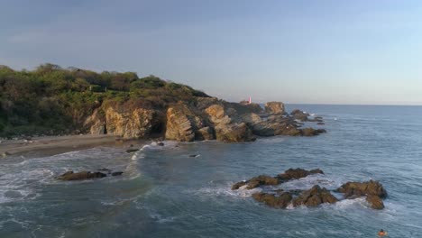 Aerial-shot-of-the-rock-formations-in-Zicatela-beach,-Puerto-Escondido,-Oaxaca