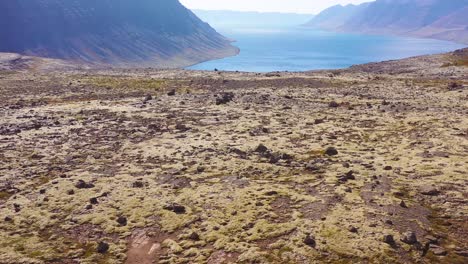 Aerial-over-a-black-camper-van-traveling-on-a-dirt-road-in-Iceland-in-the-Northwest-Fjords-3