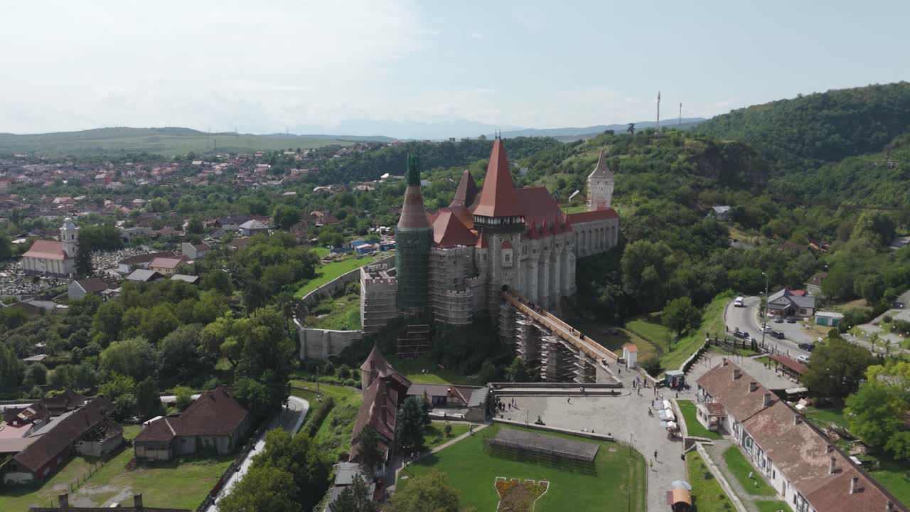 Aerial shot showcasing the medieval fortress and its dramatic architecture in the Transylvanian landscape