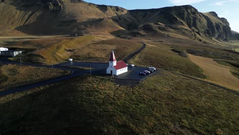 church chapel in breathtaking iceland mountain landscape in vik, aerial