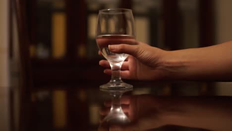 Hand-pick-up-wine-glass-with-water-in-it