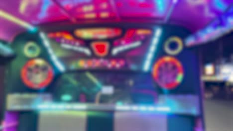 colorful lights illuminate a tuk-tuk interior, creating a lively nightlife atmosphere during a nighttime ride in bangkok