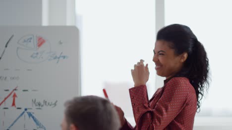 happy afro woman laughing during business presentation in boardroom