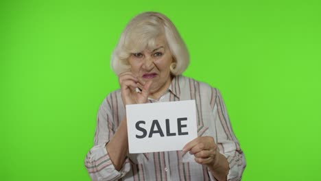 abuela mostrando la nota de inscripción de la palabra de venta, satisfecha con los precios bajos, comprando el viernes negro