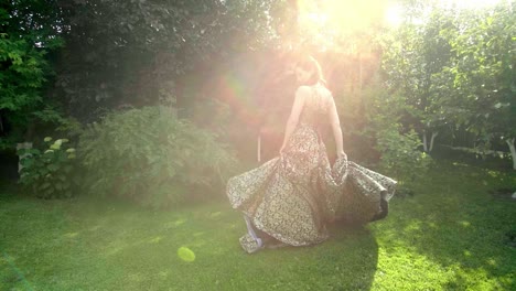 woman in a golden dress in a garden
